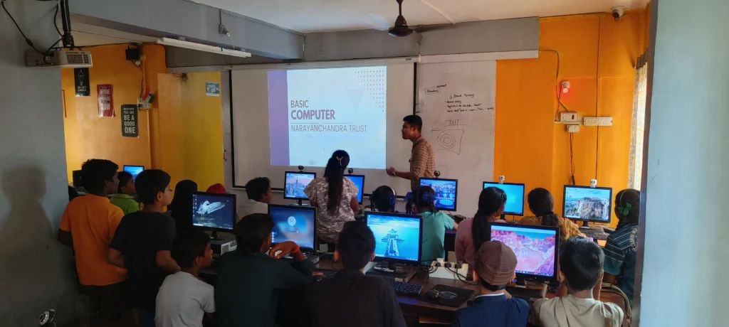 An instructor teaching students basic computer skills in a classroom.